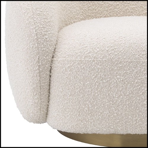 Details of the bouclé cream fabric and stainless steel brushed brass finish base of the rotative Armchair Eichholtz Brice
